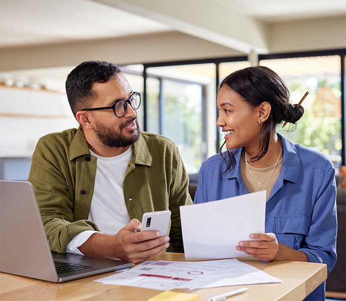 Smiling couple looking at insurance documents